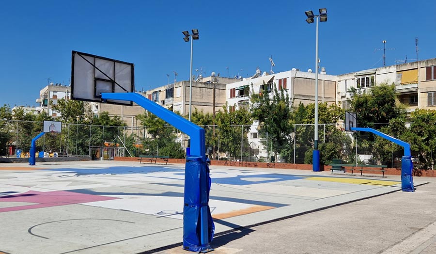 View of a sports court, with housing blocks in the background