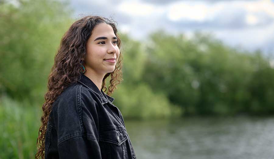 Carola looking wistfully away from the camera by a London lake