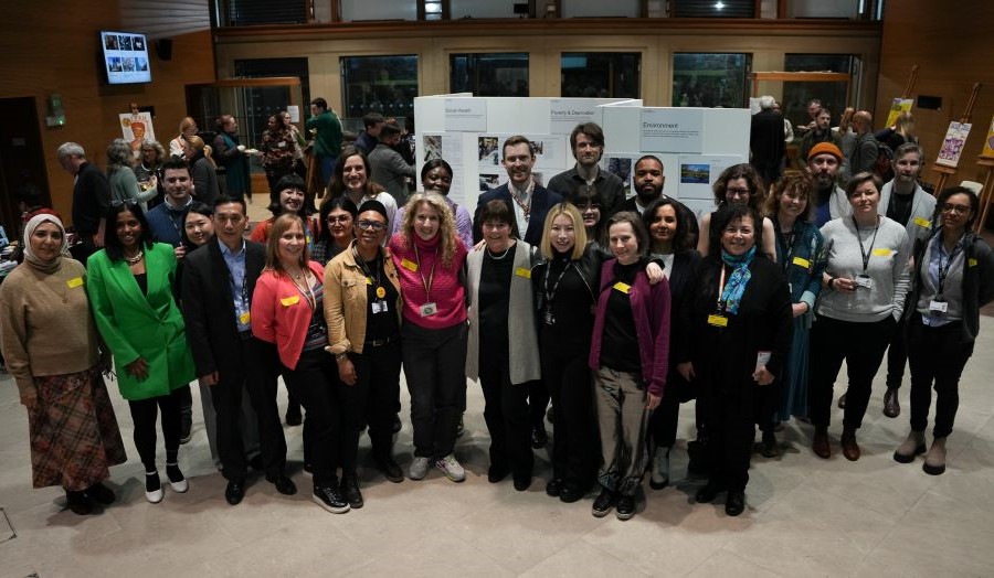 a group of people standing together in an auditorium