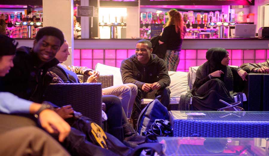 A group of undergraduate students sitting at a table in the Rocket