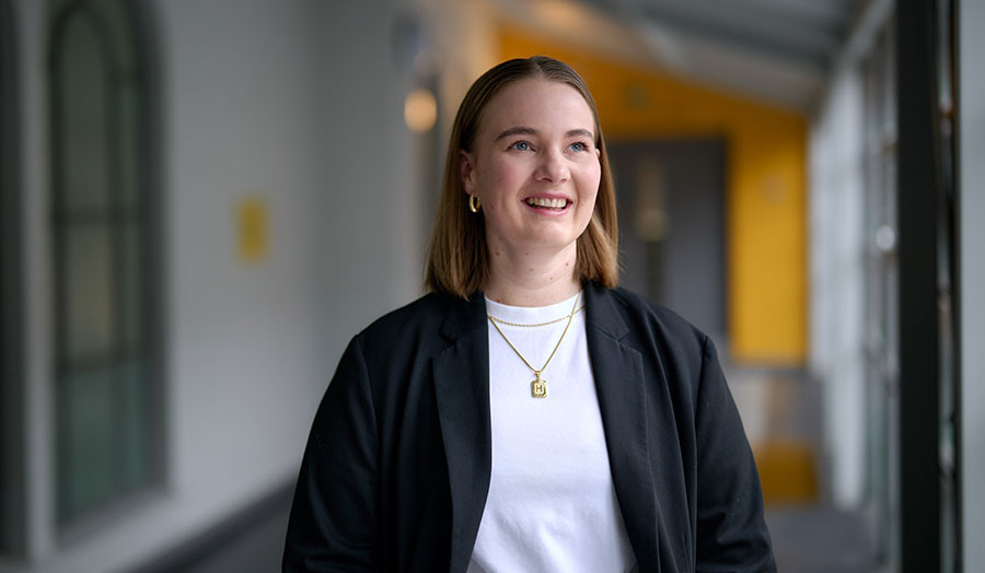 Hanne Noraas smiling in a corridor at London Met